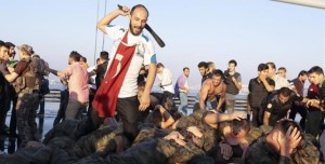 Surrendered Turkish soldiers who were involved in the coup are beaten by a civilian on Bosphorus bridge in Istanbul